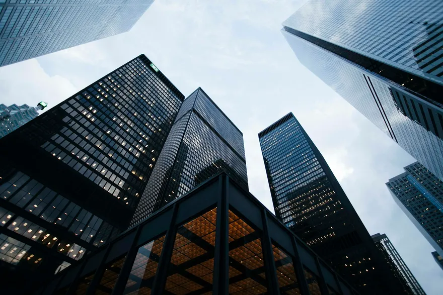 Skyscrapers seen from below, converging toward the sky