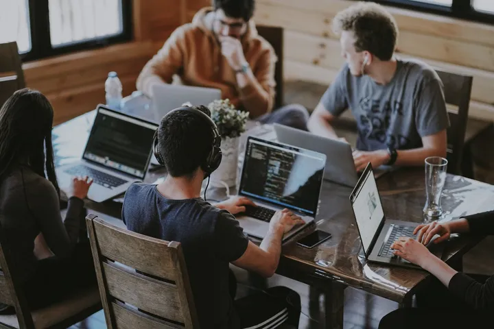 Team working together on laptops around a shared table