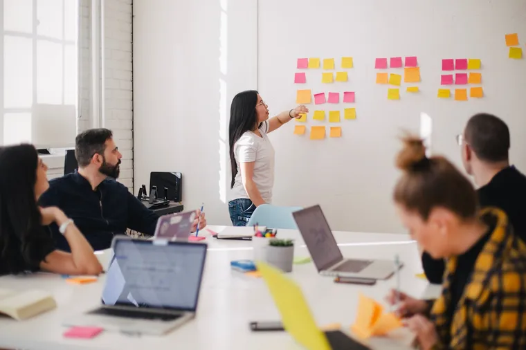 Team planning session with notes arranged on a wall